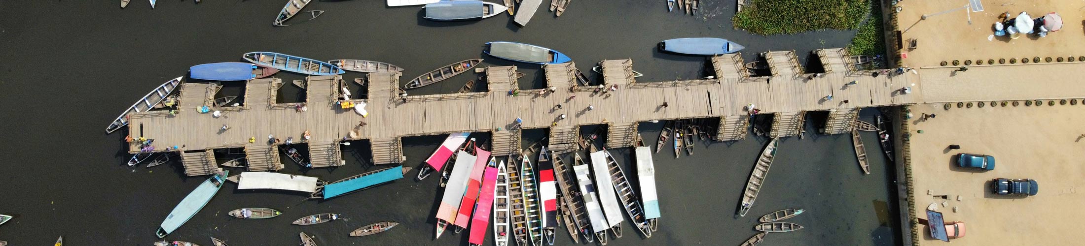 A jetty with pointed boats photographed from above