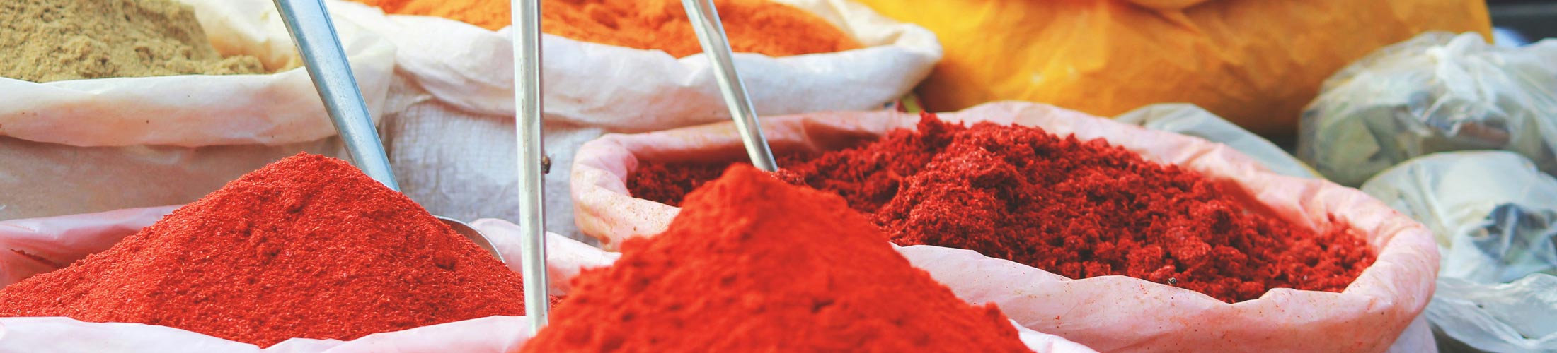 A close-up of colorful spices in cloth bags